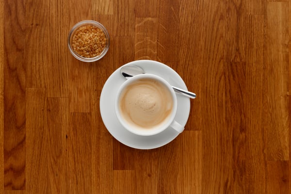 walnut worktop with a cup of coffee on it